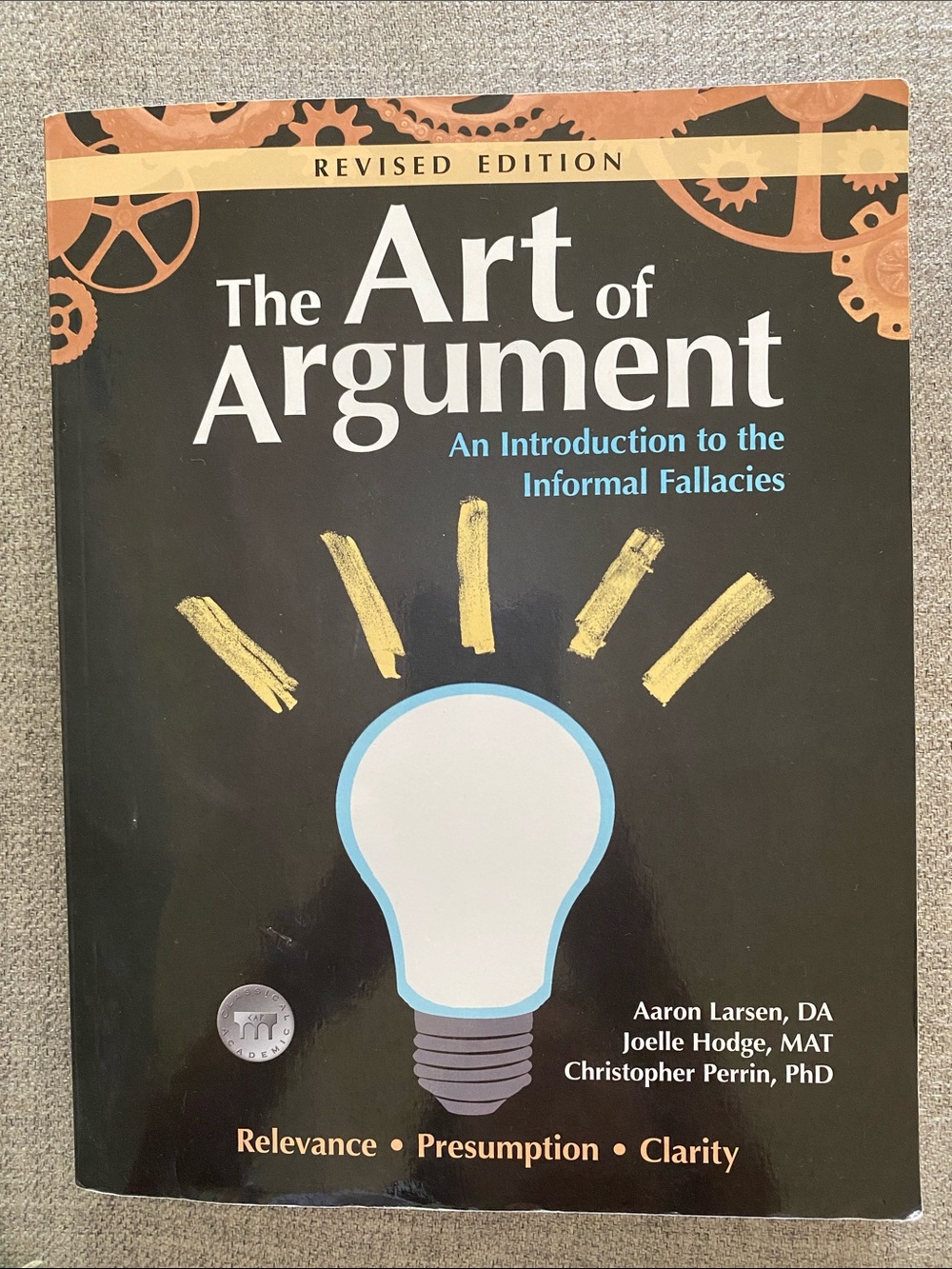 The Art of Argument - Black Cover Light Bulb Design